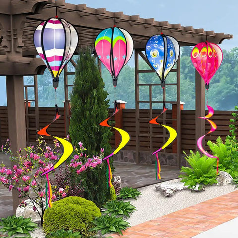 Four Pack Colorful Hot Air Balloon Wind Spinners For Yard Decor With Curly Tails That Spin In The Wind hung in garden
