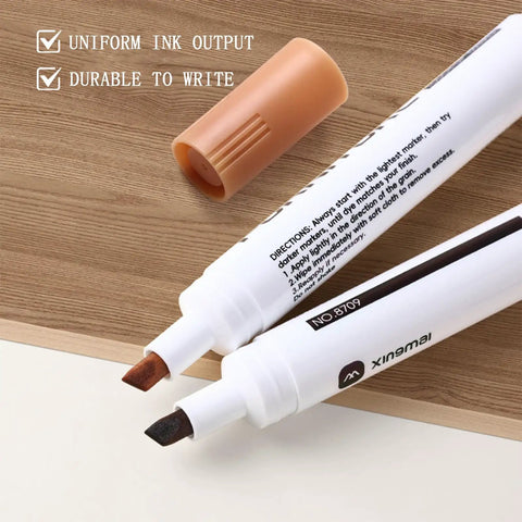 Easy Peasy Furniture Markers And Wood Scratch Repair Pens With No Sweat Color Match Swatch Card for scuffed floors desks tables. Two wood repair markers in brown and black on a wooden surface.