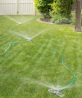 Port-A-Rain Above-Ground Sprinkler System For Flexible Yard Watering on green lawn with even water spray distribution, no-dig setup.