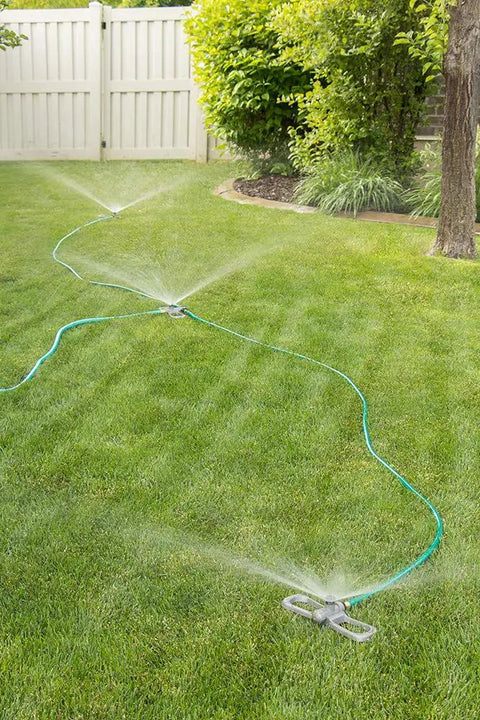 Port-A-Rain Above-Ground Sprinkler System For Flexible Yard Watering on green lawn with even water spray distribution, no-dig setup.