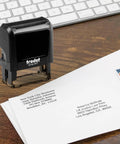 Custom Self Inking Signature Stamp Personalized With Your Favorite Fonts And Rich Ink Colors Serves Up Hassle Free Branding For Work Or Play Designed As A Top Shelf Game Changer on a wooden desk with envelopes.
