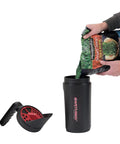Pouring seed into EarthShaker Hand Spreader 4 lb capacity with four option dial lid for easy refilling fertilizer ice melt rock salt grass seed and more