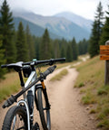 Mountain bike on a forest trail with signposts and mountains in the background, ideal for multi-speed rigs on street, mountain, or city bikes.