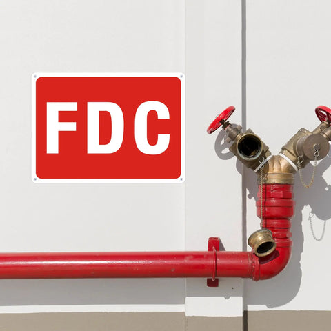 Rock Solid 2 Pack FDC Sign For Fire Department Connection Made From Premium Aluminum Outdoor Plaque on wall near red pipes.