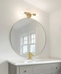 Two Light Matte Brass Vanity Light With Open Sockets Reversible Mount above a bathroom mirror