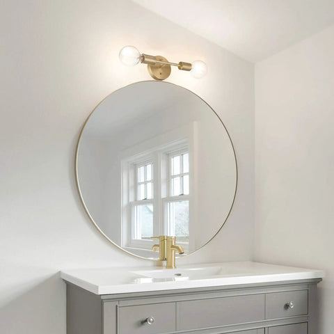 Two Light Matte Brass Vanity Light With Open Sockets Reversible Mount above a bathroom mirror