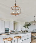 Rustic Bronze Farmhouse Six Light Drum Chandelier hanging over modern kitchen island with wooden stools and decor