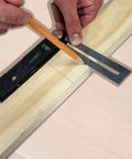 User marking a straight line on wood with the Straight Shooter Nine In One Measuring And Marking Tool Featuring Dual Levels Sliding Bevel Depth Gauge 45 Degree Miter Lines And Scribe Designed For Hardcore Builders.