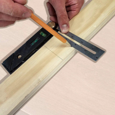 User marking a straight line on wood with the Straight Shooter Nine In One Measuring And Marking Tool Featuring Dual Levels Sliding Bevel Depth Gauge 45 Degree Miter Lines And Scribe Designed For Hardcore Builders.