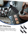 Dope New Compact Travel Makeup Palette With Mirror, Four Pack Empty Eyeshadow Containers on a vanity with cosmetics.