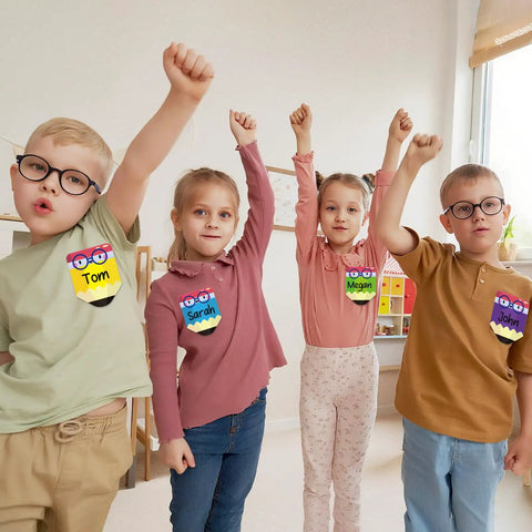 Children wearing Colorful 36 Pack Pencil Desk Name Plates With Waterproof PET Film For Classroom Organization And Student Name Tags