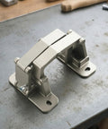 Straight Up Heavy Duty Conceal Hinge For Stone Doors And Fire Cabinets on a workbench, showcasing smooth operation and precision cast design.