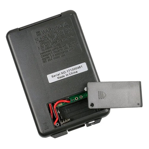 Back view of Pocket Digital Multimeter Handy Little DMM For AC DC Measurements showing battery compartment and serial number.