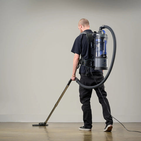 Man using Powerhouse Lightweight Bagless Backpack Vacuum With Killer Suction on hard floor, demonstrating efficient cleaning.