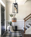 Entryway with Dope Modern Black Industrial Farmhouse Pendant Light, rectangle metal cage chandelier above, stylish decor.