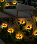 16 Pack Solar Sunflower Garden Lights LED solar powered waterproof stakes illuminating a patio with outdoor furniture