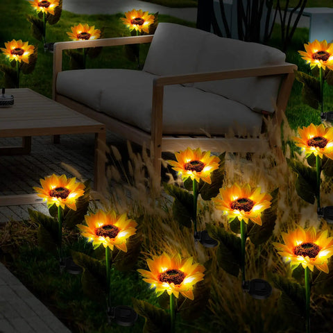 16 Pack Solar Sunflower Garden Lights LED solar powered waterproof stakes illuminating a patio with outdoor furniture