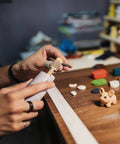 Person using Pro Grit Diamond Grinding Wheel For Electric Glass Grinders With Brazed Abrasive Disc for crafting figures.