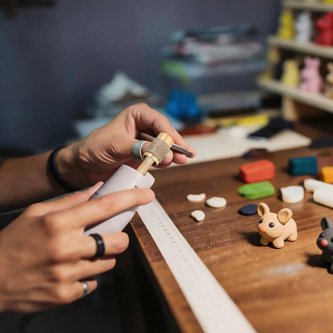 Person using Pro Grit Diamond Grinding Wheel For Electric Glass Grinders With Brazed Abrasive Disc for crafting figures.