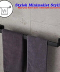 24 Inch Contemporary Stainless Steel Towel Bar Wall Mount With Slick Matte Black Finish holding towels in modern bathroom.