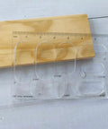Reliable Acrylic Router Template For Woodworking Diy Bowtie Joint And Grommet Inlay Guide Kit Quarter Inch Thick Laser Cut Jig Tool on a wooden surface.