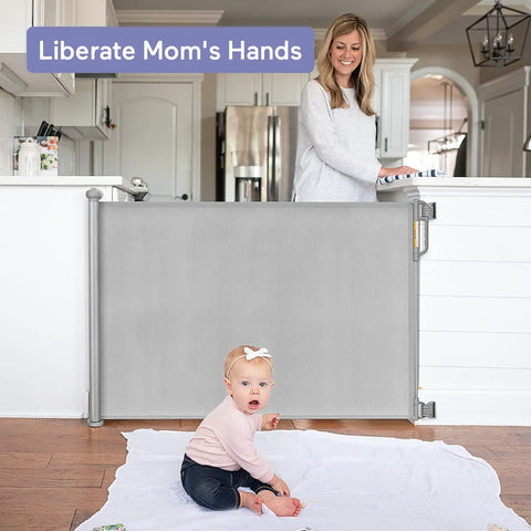 Retractable Baby Gate For Stairs And Doorways, 33 Inch Tall, Expands To 55 Inch Wide, shown with baby and mother in living room
