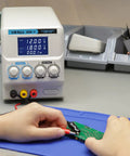 Person using Regulated Variable DC Bench Power Supply 0 To 30V And 0 To 5A Low Noise Switch Mode with alligator clips on circuit