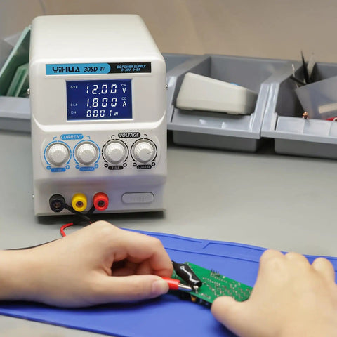 Person using Regulated Variable DC Bench Power Supply 0 To 30V And 0 To 5A Low Noise Switch Mode with alligator clips on circuit