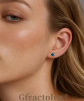 Woman wearing Implant Grade G23 Titanium Opal Earrings Screwback Studs with 5mm sharp centerpiece, showcasing style and comfort.