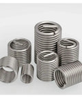 Fine Thread Repair Insert Kit For M6 To M16 In 304 Stainless Steel Helicoil Bushing set shown arranged on a surface