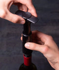 Person using a wine saver pump with Three Pack Vacuum Wine Stoppers Set For All Bottle Sizes Reusable Rubber Cork Alternative