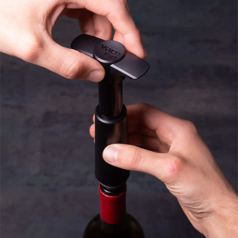 Person using a wine saver pump with Three Pack Vacuum Wine Stoppers Set For All Bottle Sizes Reusable Rubber Cork Alternative