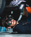 Man wearing Two Pack Kickass Welding Safety Goggles With Quick Flip Cover and Slip Resistant Adjustable Headband for shop work.