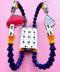 Soldering Clamp For Stained Glass And Jewelry Making, four adjustable arms with stained glass pieces, pink background