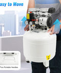 Man carrying a compact 10 Gallon Oil-Free Air Compressor 1HP Ultra Quiet Vertical Steel Tank 115 PSI with portable handles.