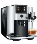 Premium Fully Automatic Chrome Espresso Coffee Machine Featuring A Hella Smooth Four Point Three Inch Smart Touchscreen Display For Twenty Seven Freshly Ground Drinks with a cup of espresso.