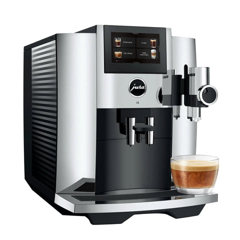 Premium Fully Automatic Chrome Espresso Coffee Machine Featuring A Hella Smooth Four Point Three Inch Smart Touchscreen Display For Twenty Seven Freshly Ground Drinks with a cup of espresso.