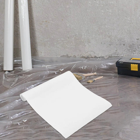 Killer Slick Clear Self Adhesive Wall Paper Roll For Kitchen Backsplash Protector And Fridge Wrap on a floor covered with plastic.