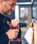 Man using drill with Heavy Duty 240 Plus 8 Pcs Sanding Discs Pad Kit For 2 Inch Die Grinder And Drill Sander Attachments