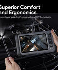 Hands holding 7 Inch IPS Endoscope With Lights And 1080P Triple Lens Borescope displaying a close-up inspection image.