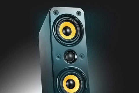 Close-up of GigaWorks T40 Series II 2.0 Desktop Speaker System with BasXPort Tech, showcasing front yellow drivers and sleek design.