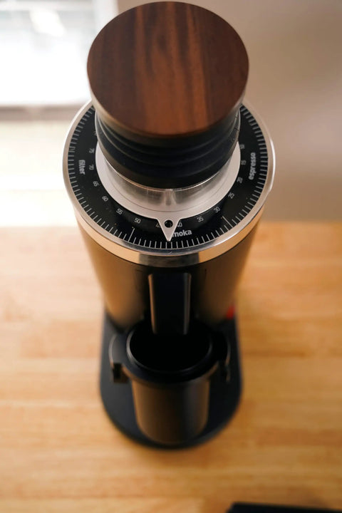 Heavy Duty 64Mm Flat Burr Electric Coffee Grinder Designed For Single Dosing Habits With Anti Popcorn Guard And Zero Static Hiccups Grinding Every Batch Bang On For Your Morning Rush In Glossy Black, overhead view with wood lid.