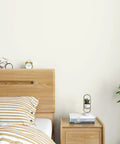 Bedroom with wooden headboard, clock, books, and plant, featuring Navy Blue Vinyl Wallpaper Self Adhesive Roll 32 By 354 Inches Waterproof.