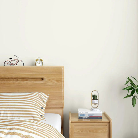 Bedroom with wooden headboard, clock, books, and plant, featuring Navy Blue Vinyl Wallpaper Self Adhesive Roll 32 By 354 Inches Waterproof.