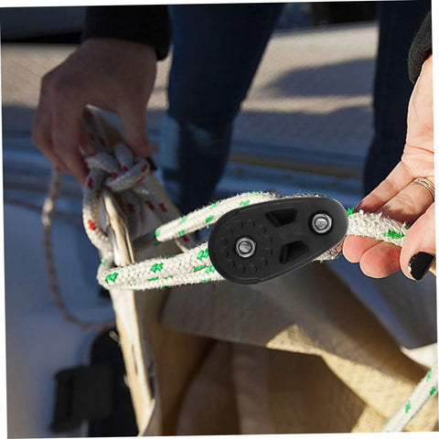 Hands holding rope through nylon block, kayak anchor trolley kit with nylon single sheave blocks for canoe and boat heavy duty bearing pulleys.