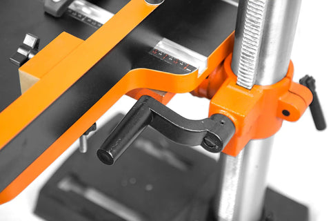 Close-up of a drill press with black and orange crank, part of the Drill Press Table With Adjustable Fence And Stop Block For Expanded Work Surface, 24 By 12 Inch Platform Fits All Drill Press Series, Clear Crank Access And Extra Workspace For Pro Level Projects.