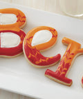 Top Shelf Cookie Decorating Tools Set Featuring Etching Wand Triple Comb And Flexible Silicone Scraper For Bakin Crews Crafting Sleek royal icing patterns on colorful letter cookies.