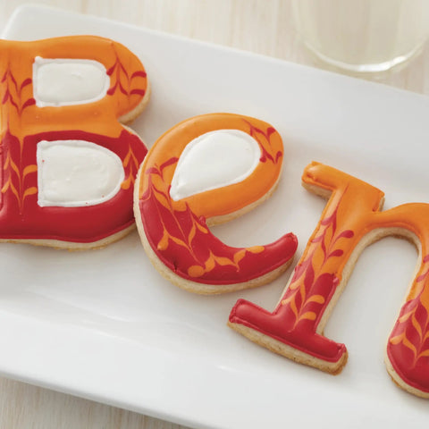 Top Shelf Cookie Decorating Tools Set Featuring Etching Wand Triple Comb And Flexible Silicone Scraper For Bakin Crews Crafting Sleek royal icing patterns on colorful letter cookies.