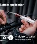 Person using All In One Shimano Hydraulic Brake Bleed Kit For Disc Brakes With 100 Ml Mineral Oil, Gloves And Bleed Block, Video Guide