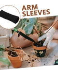Super Heavy Duty Cut Resistant Arm Sleeves Delivering Rock Solid Forearm Coverage Against Thorns And Gritty Scrapes For Weekend Yard Work Or Serious Shop Grind Featuring Slip On Stretch Fabric And A Snug Fit That Goes The Distance, black woven sleeves being used for potting plants.